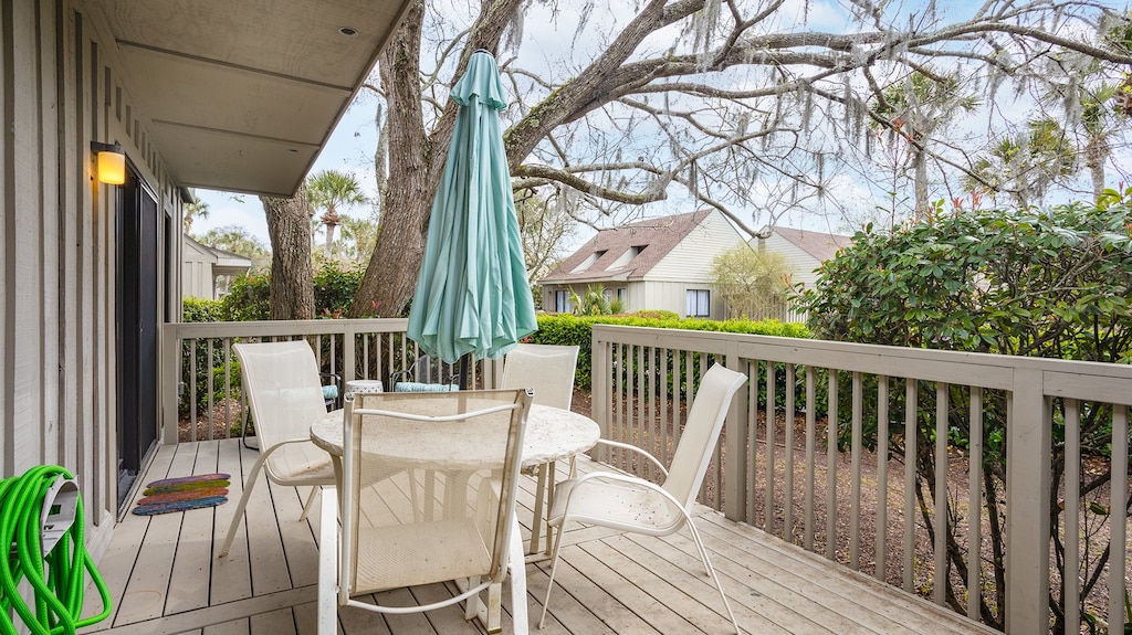 This private deck creates a quiet outdoor retreat, framed by tropical landscaping and soft gravel underfoot.