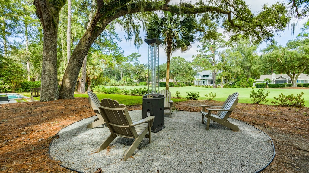 A circle of Adirondack chairs surrounds a tall heater, creating a year-round spot for relaxing, unwinding, right next to the golf course.