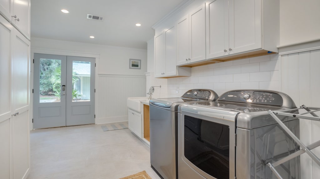 Well-designed laundry room offers exceptional functionality with full-size washer and dryer, custom cabinetry, and generous counter space for folding and organization.