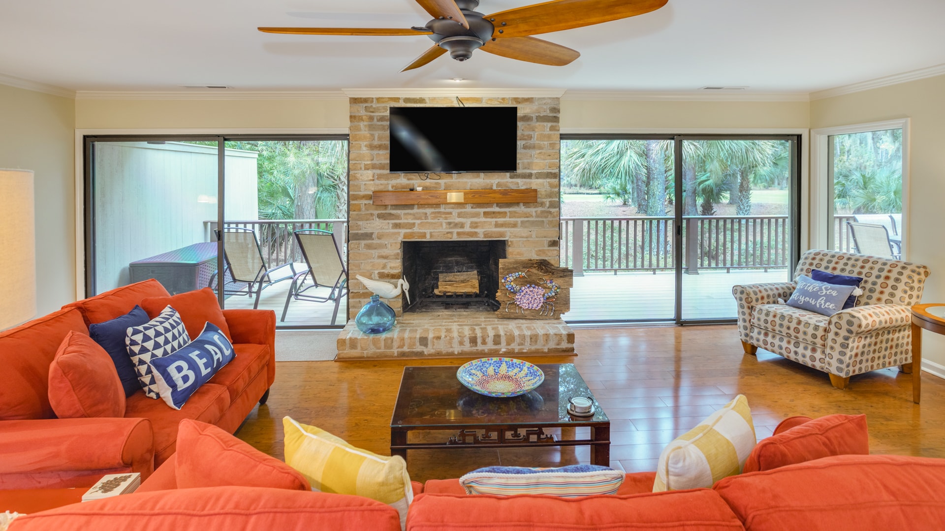 This inviting living space combines comfort and character with a classic brick fireplace as the focal point.