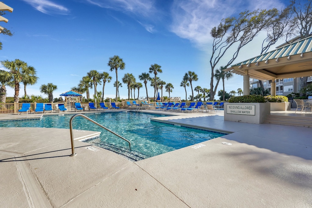 Multiple pools, expansive sun decks, and shaded seating areas create an ideal setting for relaxing between beach walks.