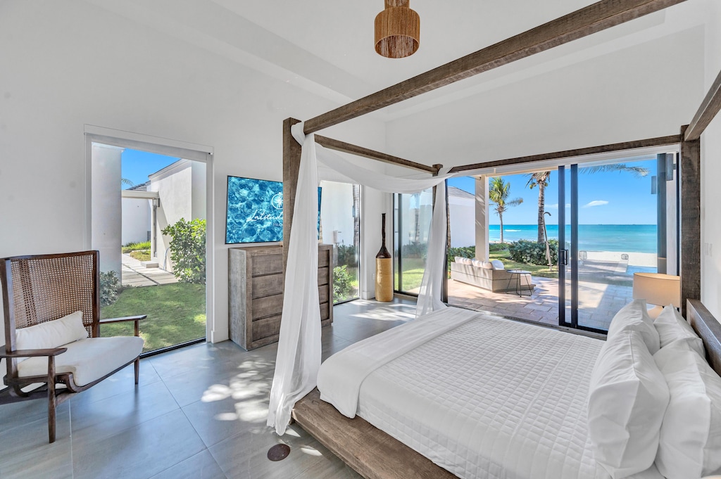 Master bedroom one offers a king bed, walk-in closet, smart tv, ensuite bathroom, and direct access to the beach and pool with its own private nook to lounge.