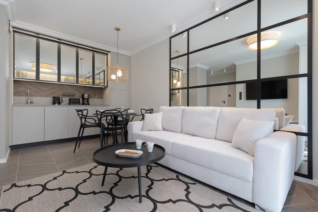 Relax in the stylish living room with a comfortable sofa and modern decor.