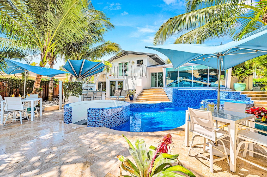 Expansive outdoor spaces offer canal views, with a cascading heated pool, lounge area, a fire pit and access to the water for a true waterfront experience.