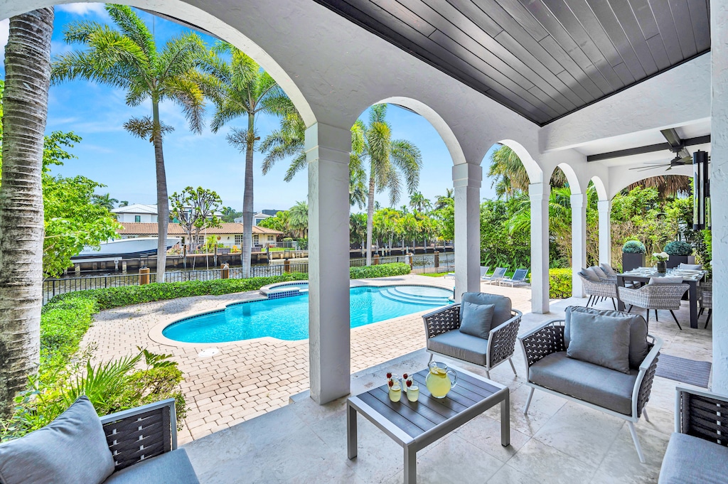 The outdoor covered patio features a lounge and dinning area.