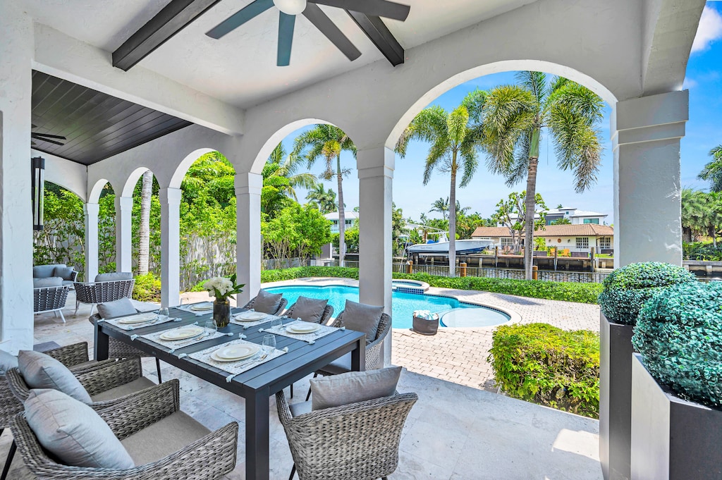 The outdoor covered patio features a lounge and dinning area.