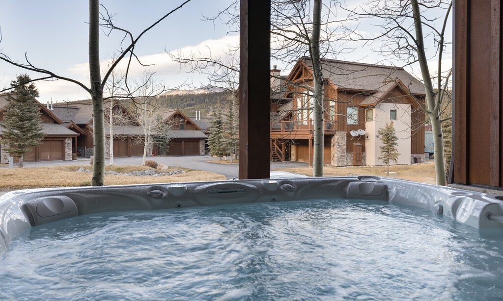 Soak in your private hot tub while taking in mountain views and alpine architecture through floor-to-ceiling windows.