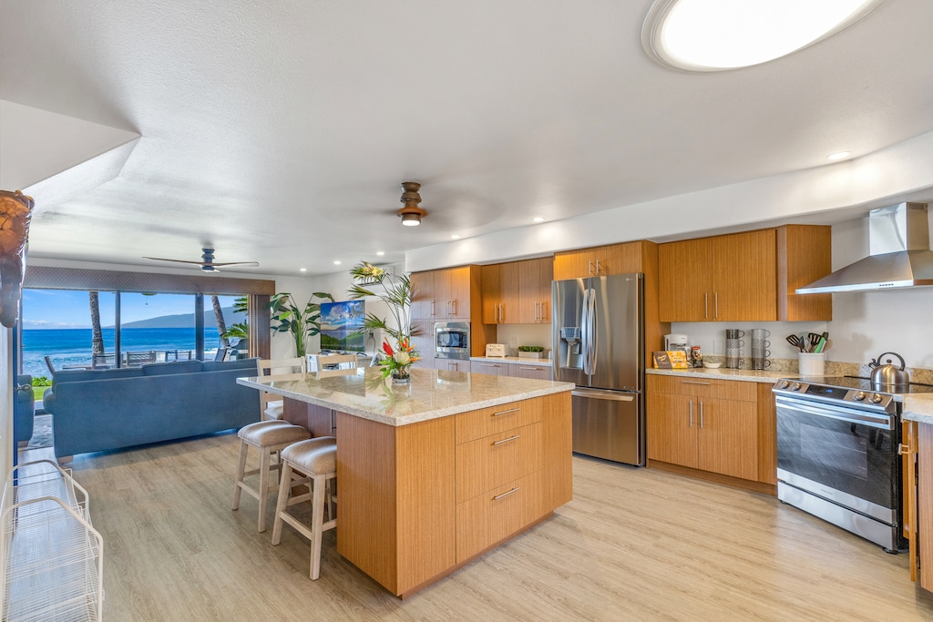 Puamana 254-2’s kitchen offers stainless steel appliances and open views to the lanai.