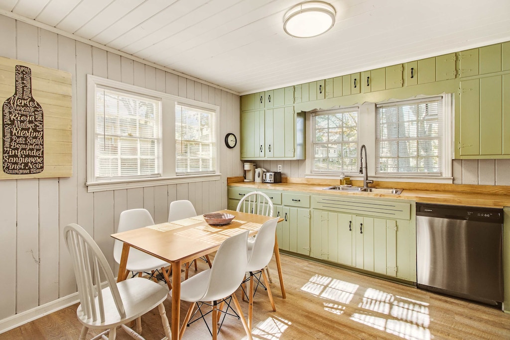 Charming kitchen with vintage cabinets and ample natural light, perfect for cozy meals.