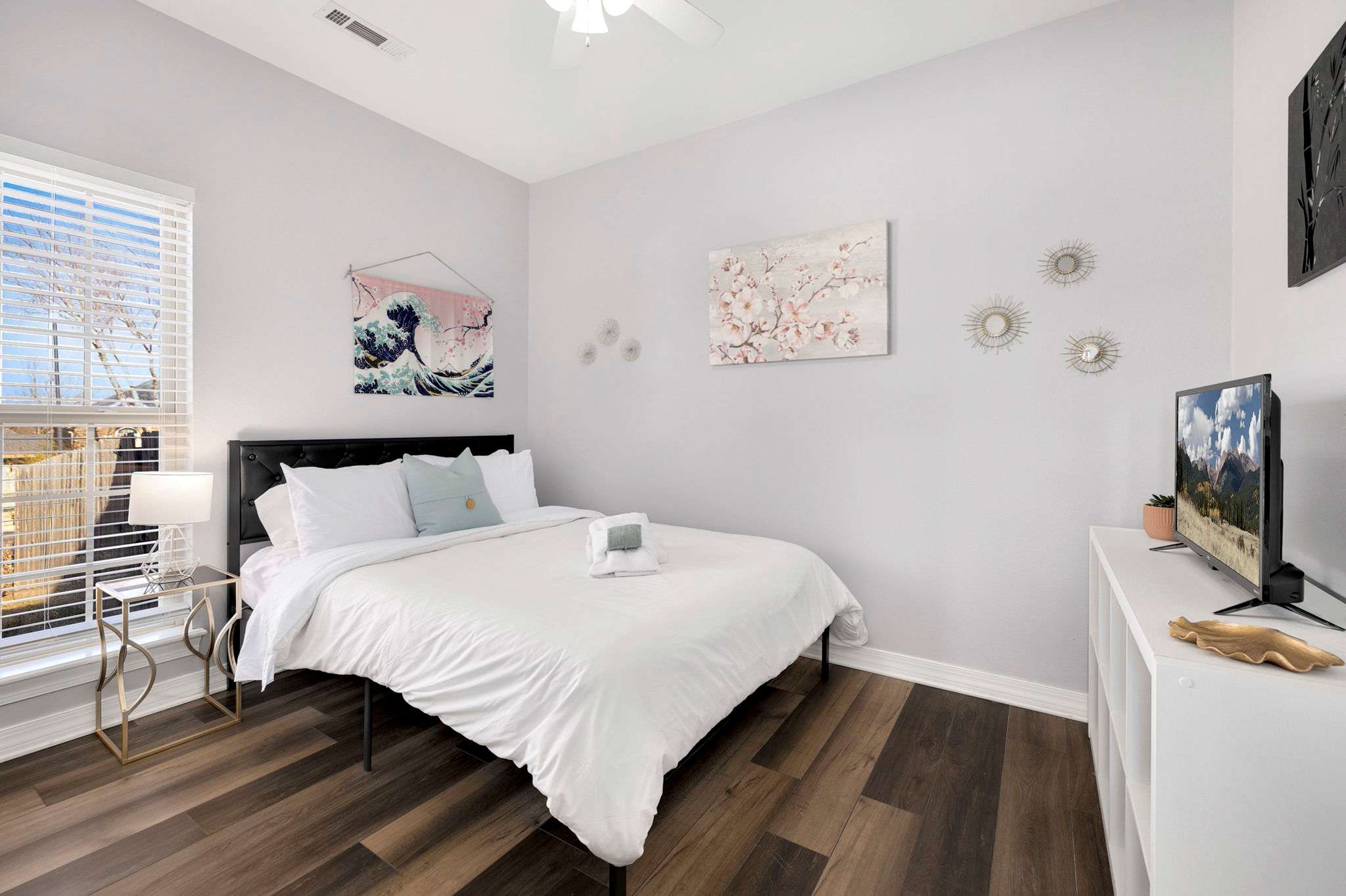 The third bedroom has a full sized bed, Smart TV, and a nearby bathroom.