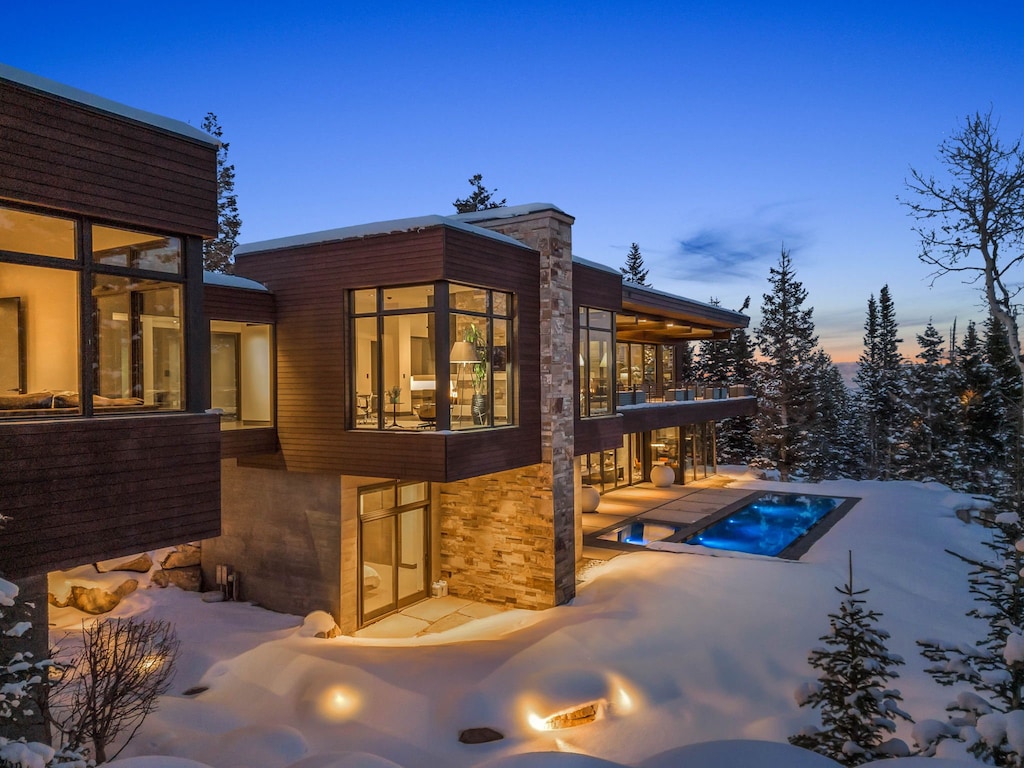 A White Pine Canyon Ranch luxury Park City vacation rental with a pool and snowy alpine views.