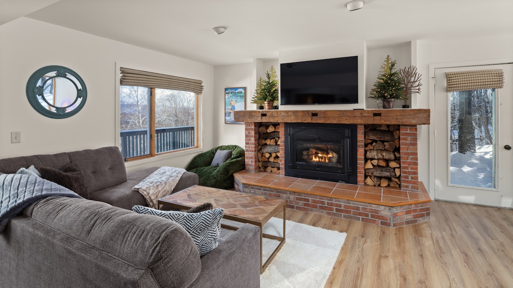 - Living room with rustic fireplace and flat screen TV for cozy nights   - Wood and stone accents create warm mountain lodge charm   - Relax in plush seating after skiing or outdoor adventures