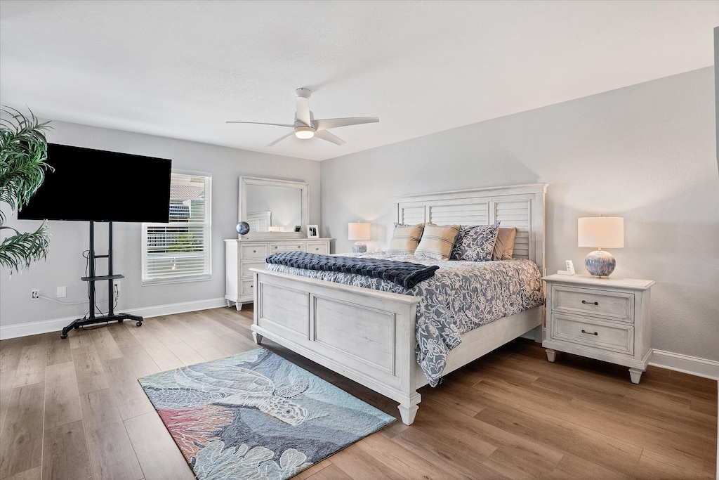 Primary bedroom with king bed, lanai access, attached bathroom, and 65-inch Roku TV
