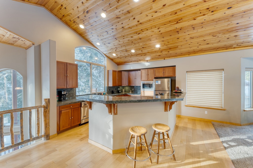 Fully equipped kitchen with a large island and barstool seating.