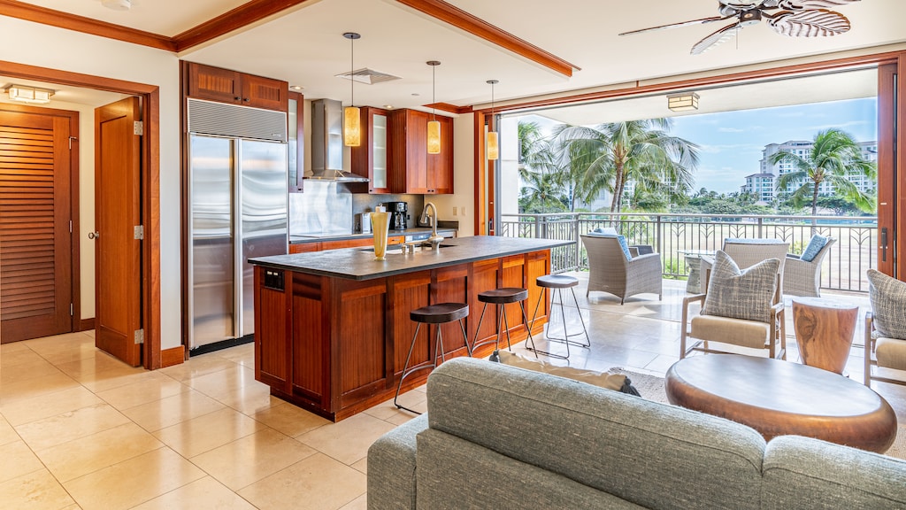 An open floor plan and bar seating in the kitchen.