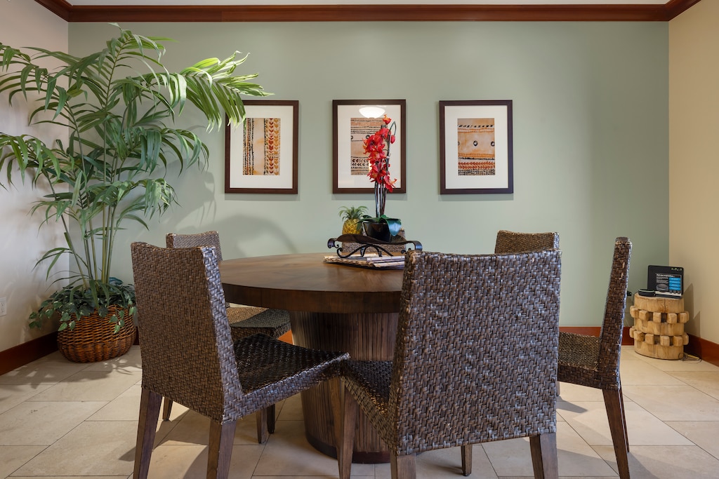 Dining area with vibrant artwork, and a large plant adding a touch of greenery.