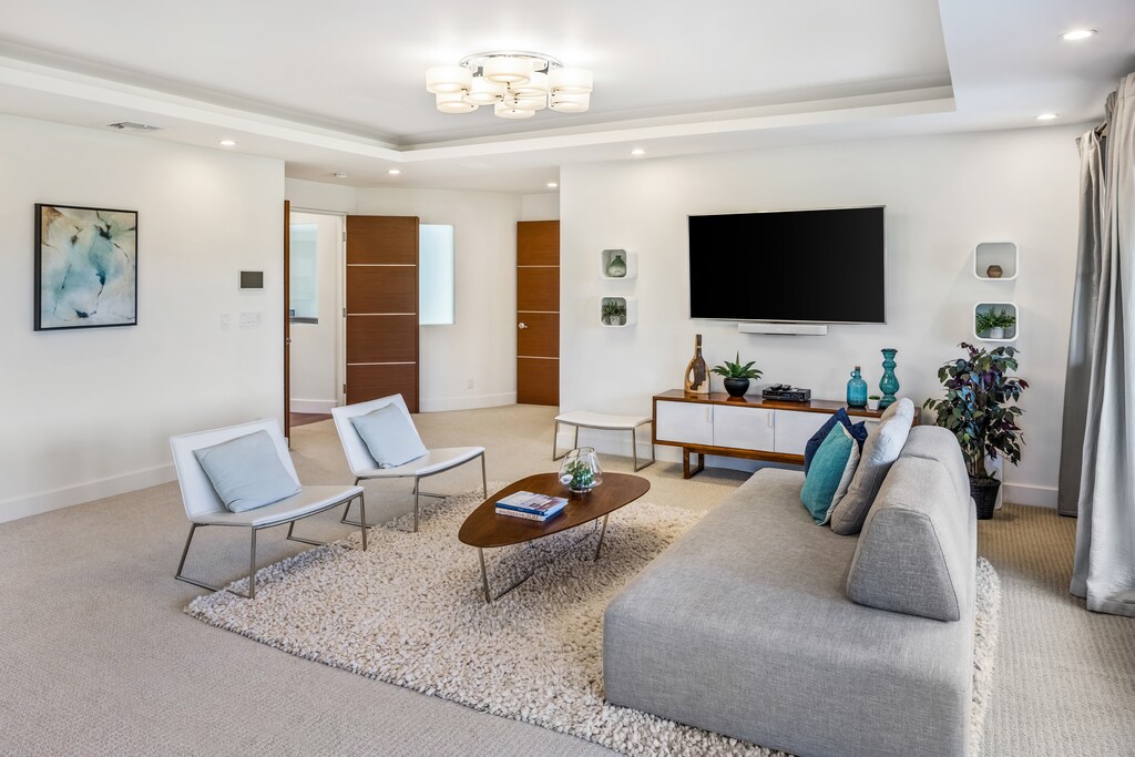 Expansive primary suite provides luxury, privacy, and direct access to the outdoor space.
