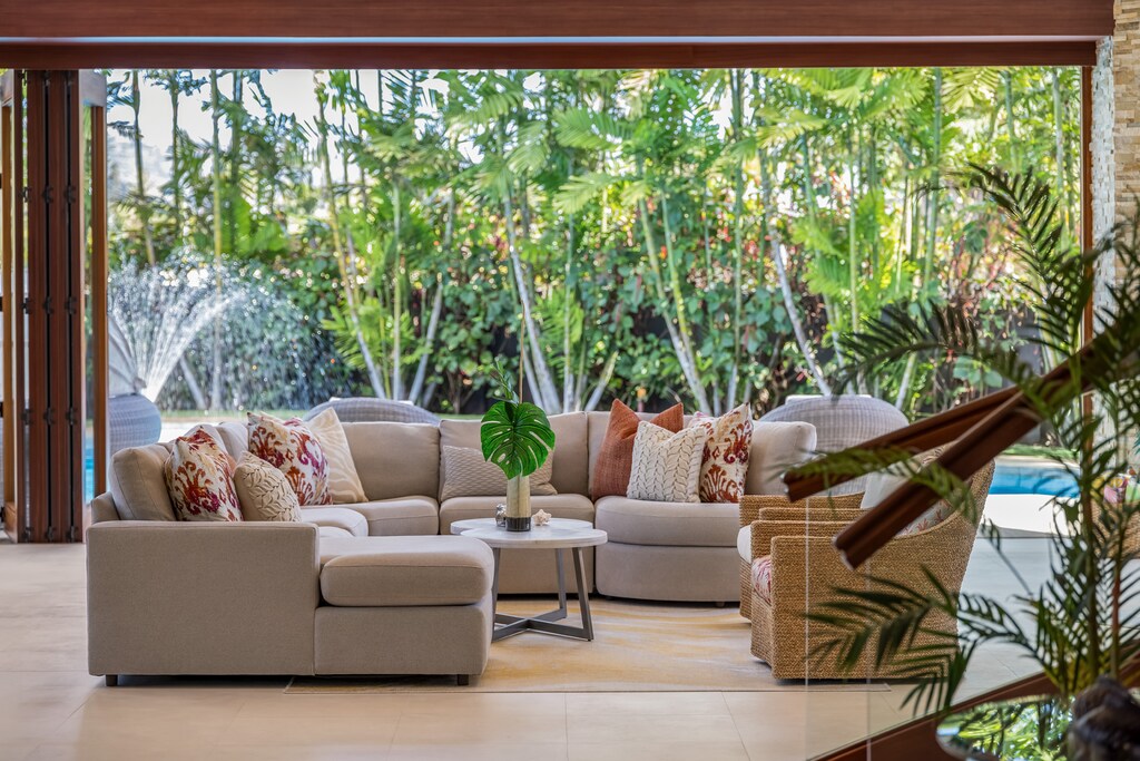 Tropical backdrop in the living area poolside with a tranquil pool's water feature.