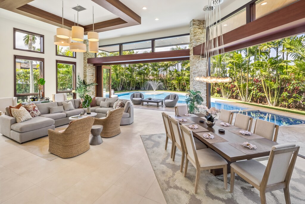 Relax and dine in the open-concept living and dining area with beautiful poolside views.