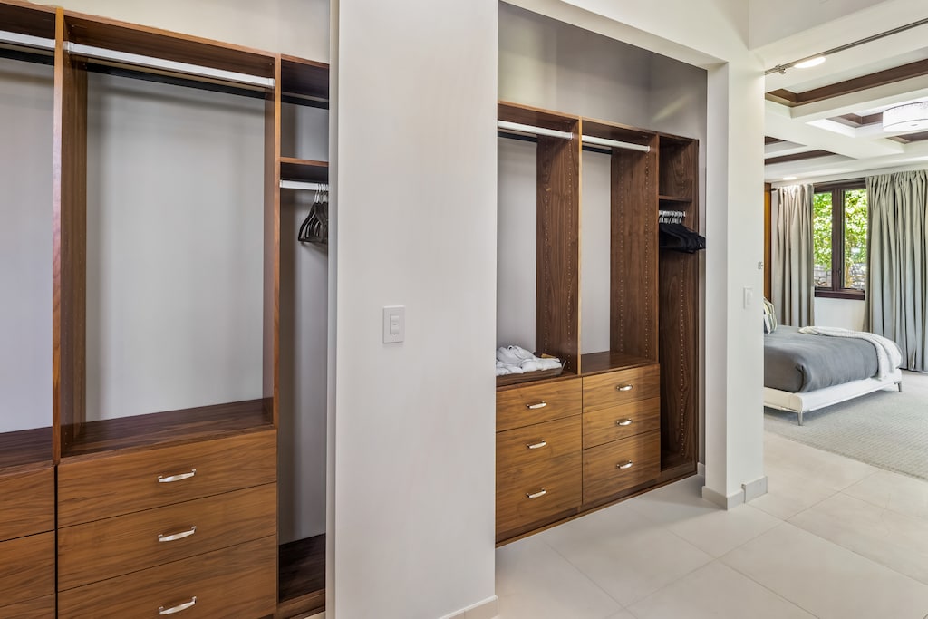 A beautifully crafted custom closet in the primary suite keeps everything organized in style.