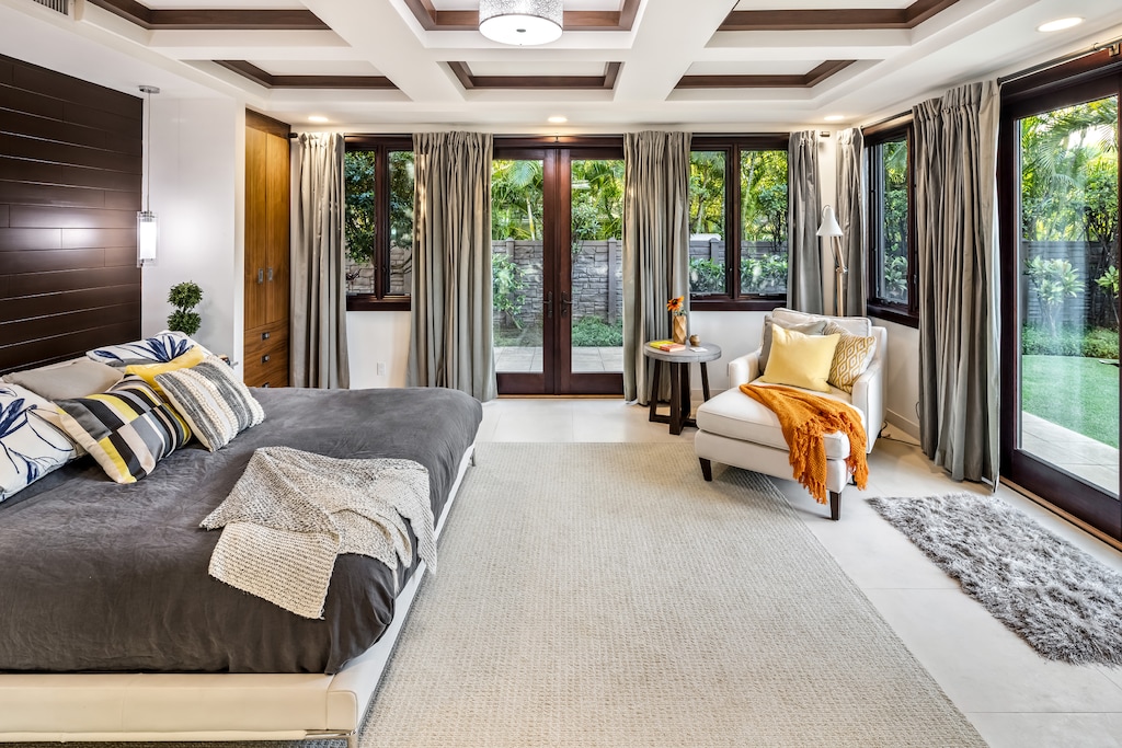 Spacious guest retreat with garden views and elegant coffered ceilings.