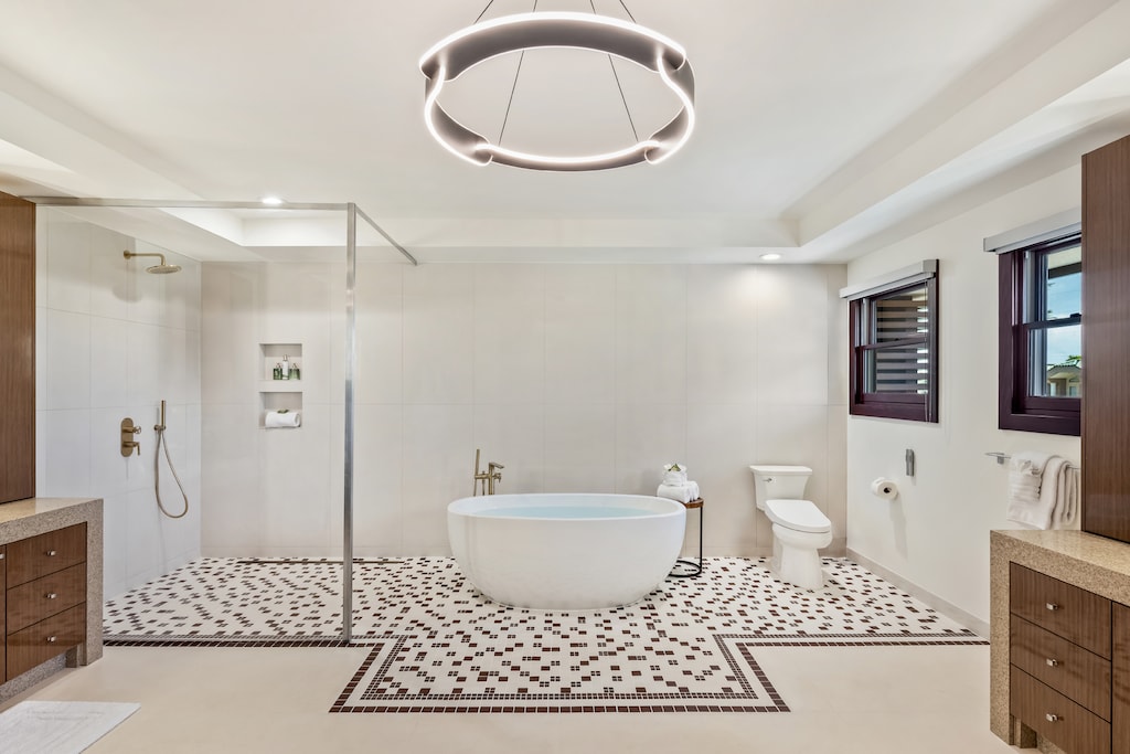 The primary ensuite features a beautiful soaker tub and a sleek glass shower for relaxation.