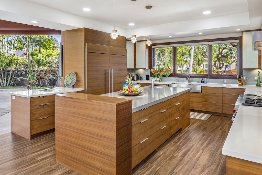 Prepare meals with ease in the modern and fully equipped kitchen with garden and pool views.