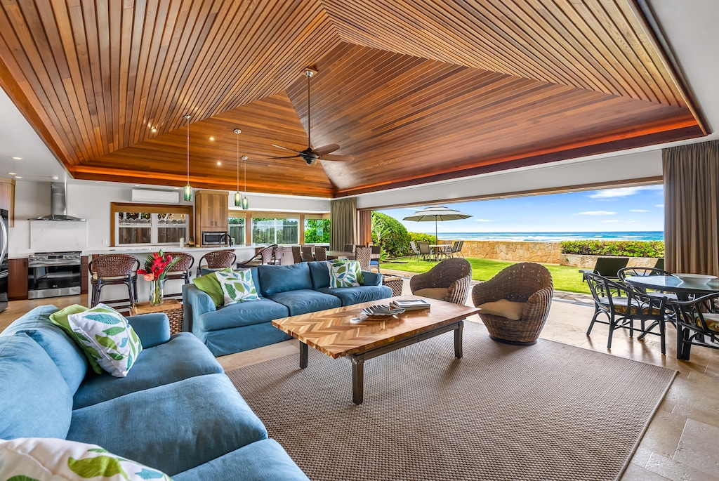 Soaring vaulted ceilings frame the oceanview living room, blending island elegance with open-air comfort.
