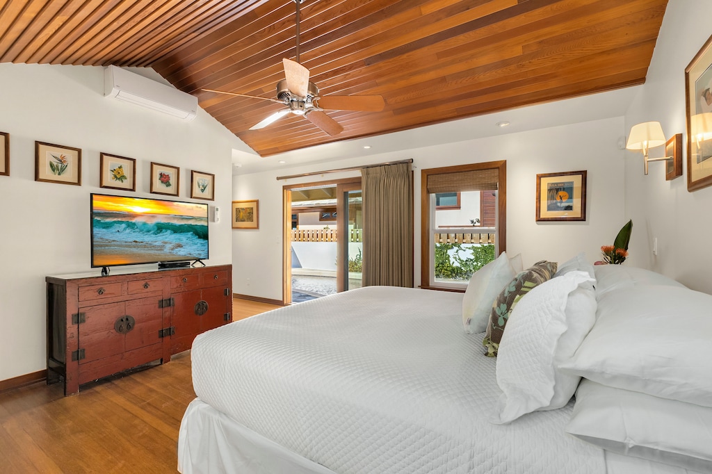 Elegant primary suite with direct access to the pool and lush backyard, combining comfort and convenience.