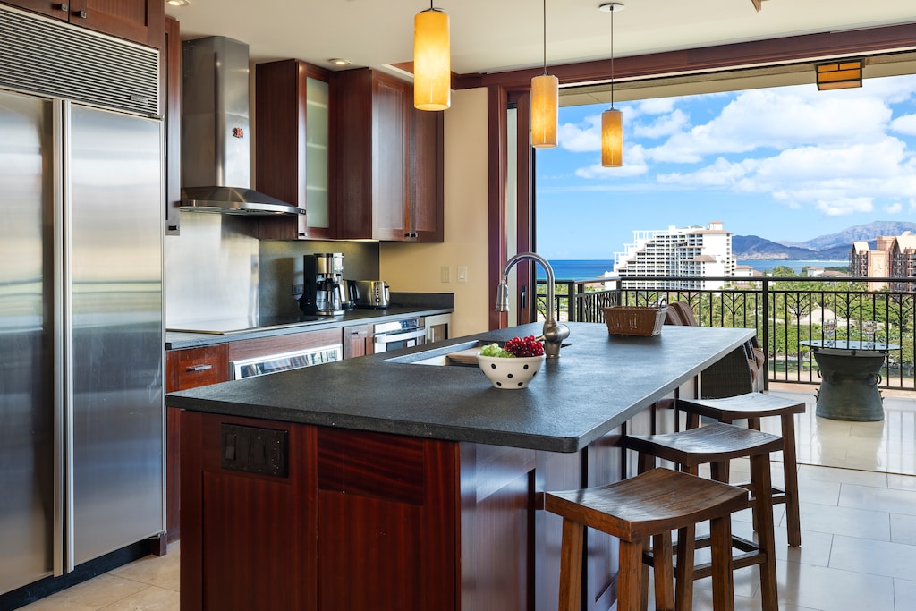 The chef’s kitchen features Sub-Zero and Wolf appliances, granite counters, and a wine cooler.