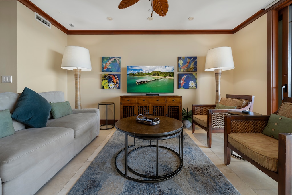 The living area features a large smart TV and comfortable seating.