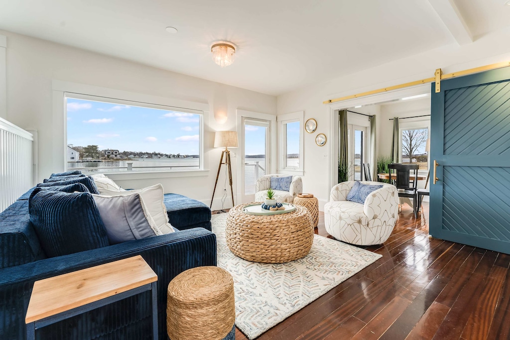 Cozy up in our living room, where expansive windows frame breathtaking waterfront views, creating the perfect ambiance for relaxation!