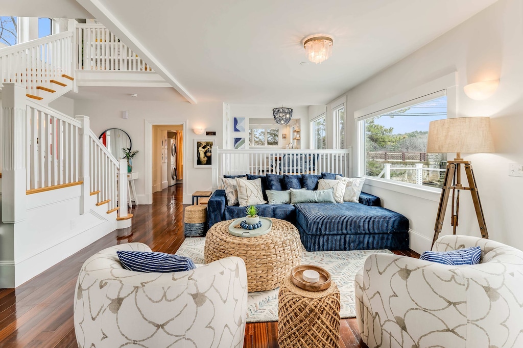 Cozy up in our living room, where expansive windows frame breathtaking waterfront views, creating the perfect ambiance for relaxation!