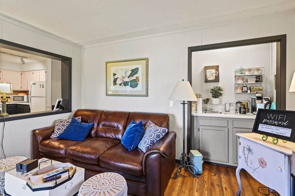 Relax on our comfy sofa with pillows, enjoy a 50" Roku TV, gather around a stylish coffee table, and feel the warmth of an indoor fireplace. Your ideal retreat.