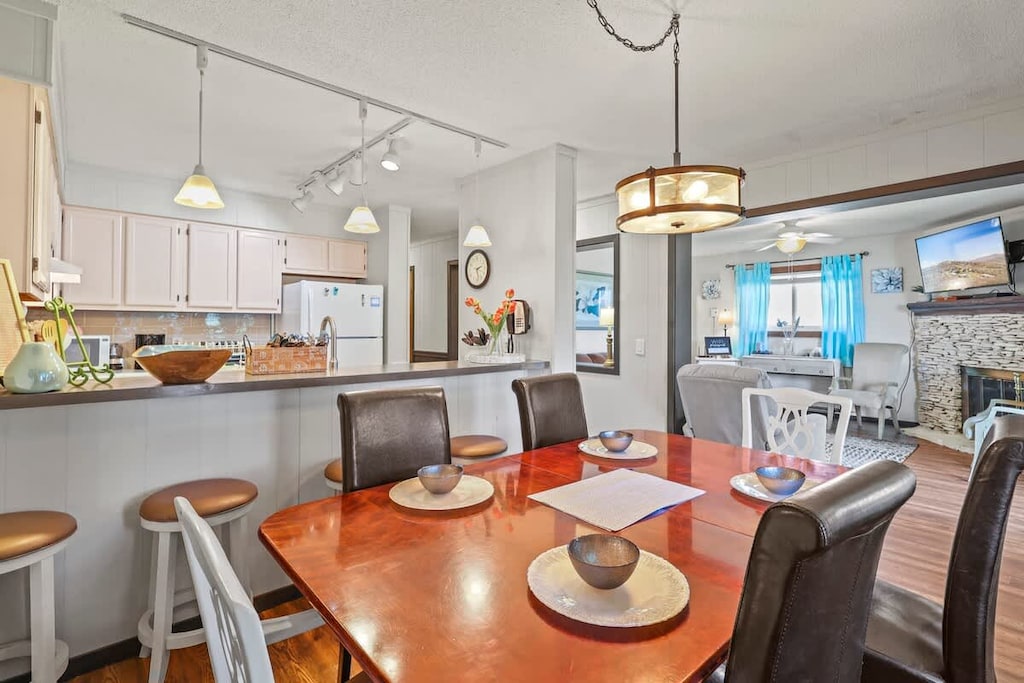 Savor your culinary delights in the connected dining room, featuring a table with seating for 6.