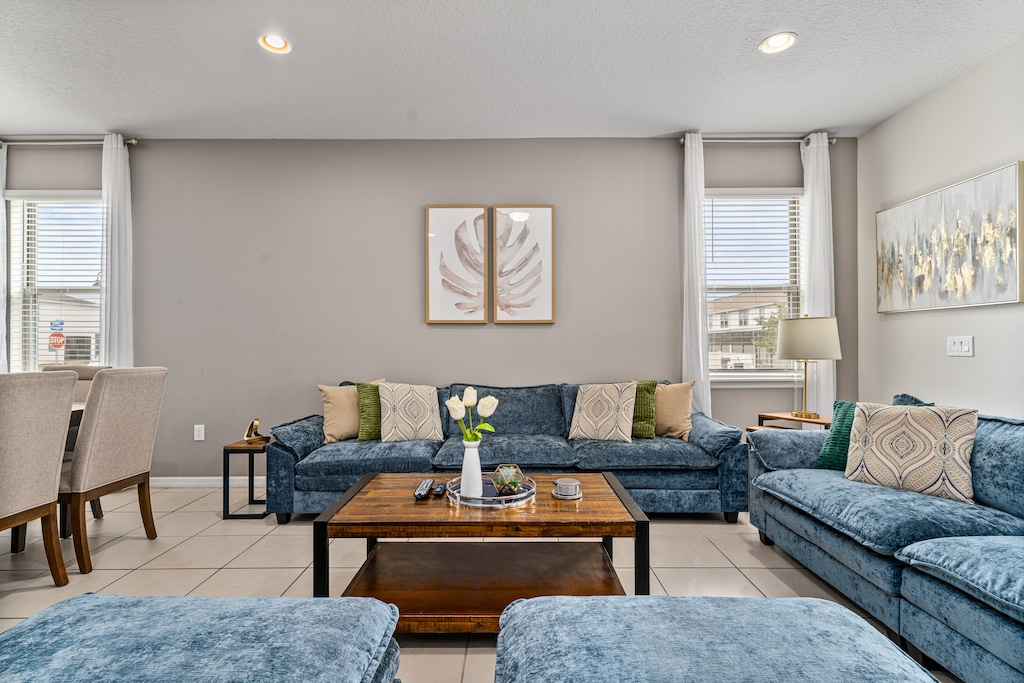 Our living room is equipped with a TV and ample plush seating, perfect for relaxation and entertainment.