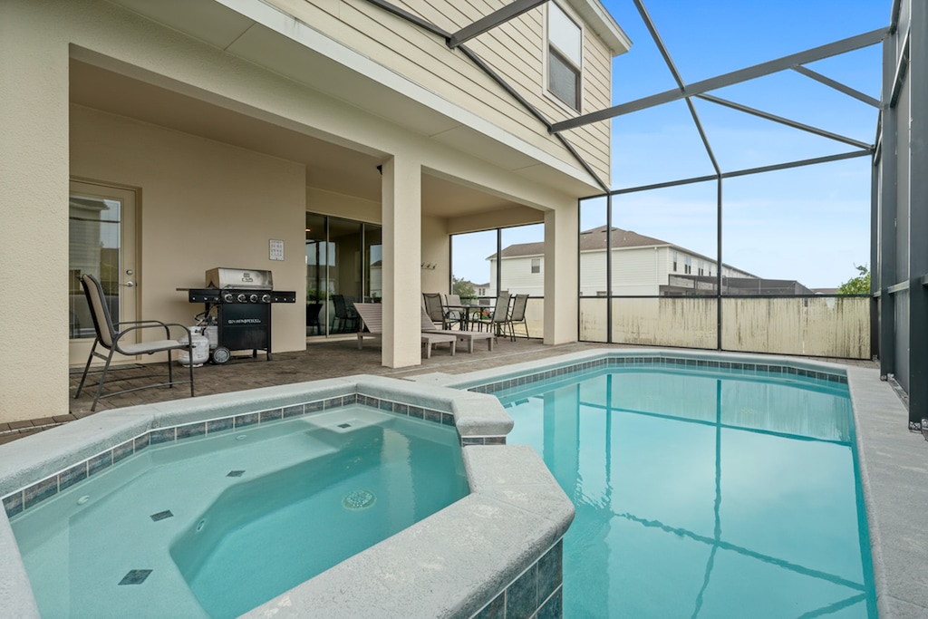 Our patio features a private pool, a BBQ grill, and a comfortable al fresco dining area to enjoy meals outdoors under the Florida sun.