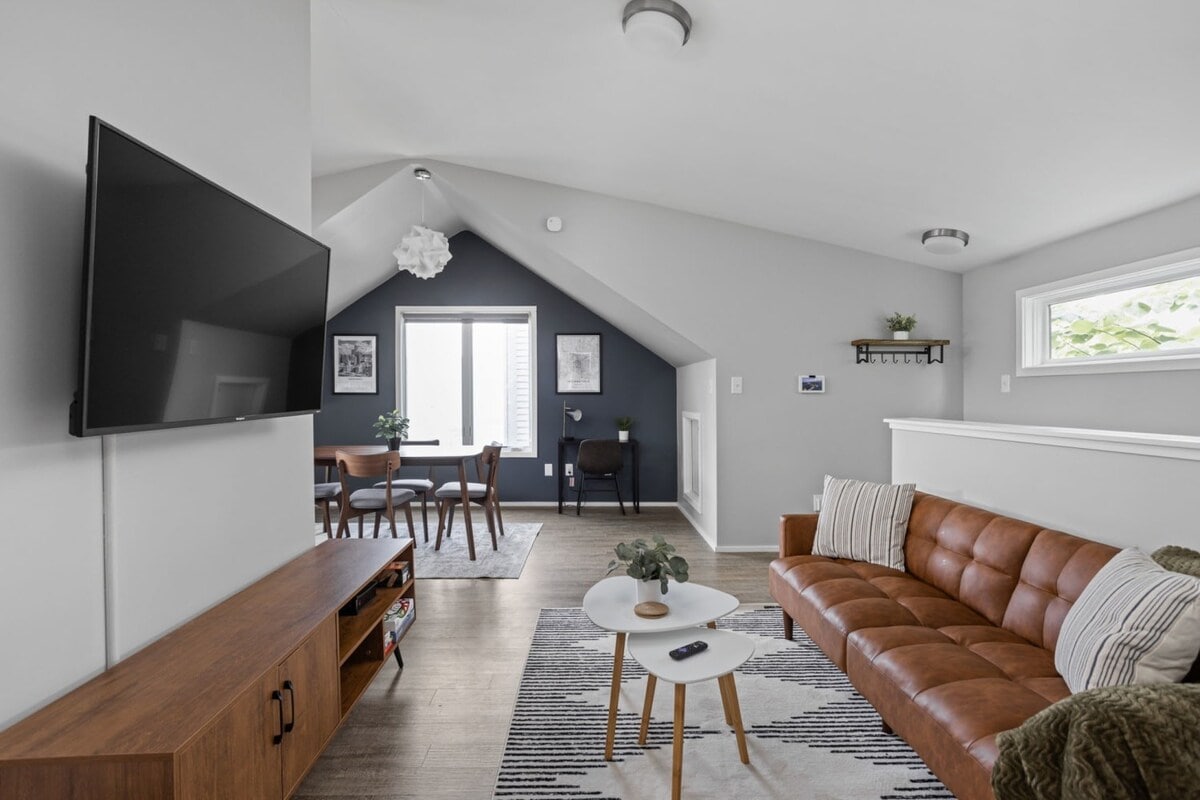 Inviting living area, complete with a TV for entertainment, a soft sofa, and a coffee table, creating a comfortable and leisurely space.