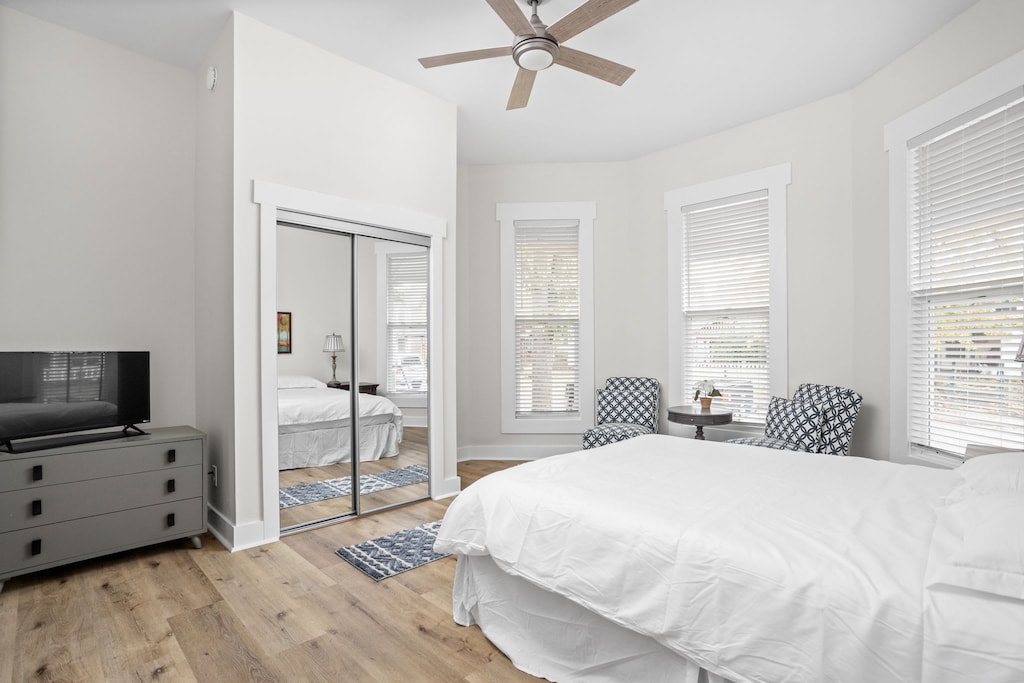 Primary Bedroom: Bright and airy retreat with modern decor and accent chairs perfect for relaxation after city adventures!