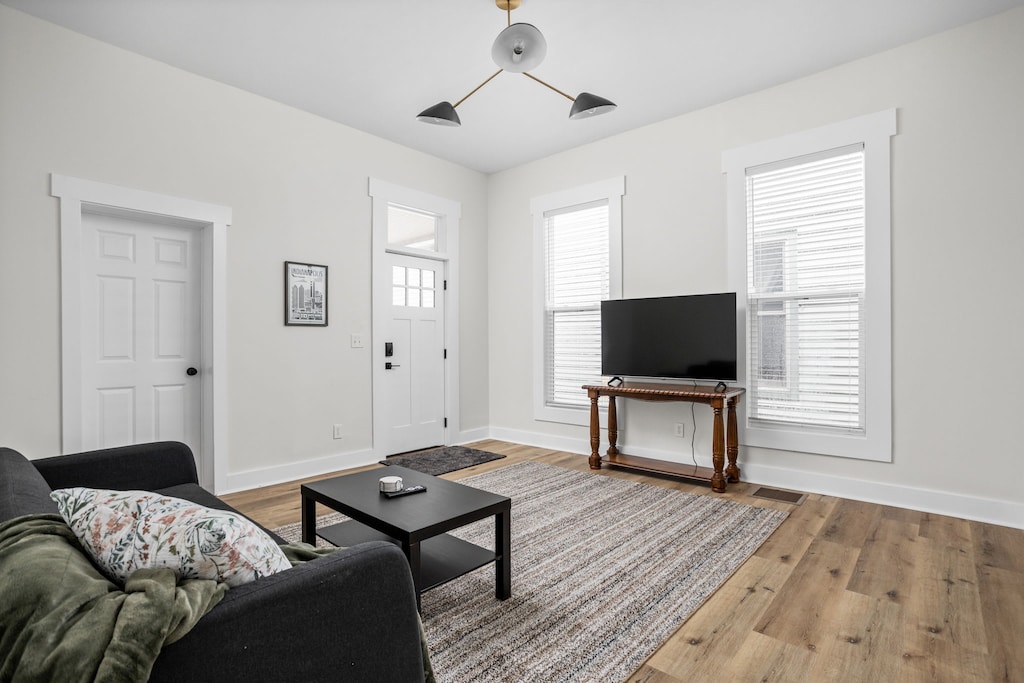 Living Room: Sunlit space with modern decor, a sleek TV, and inviting plush seating!