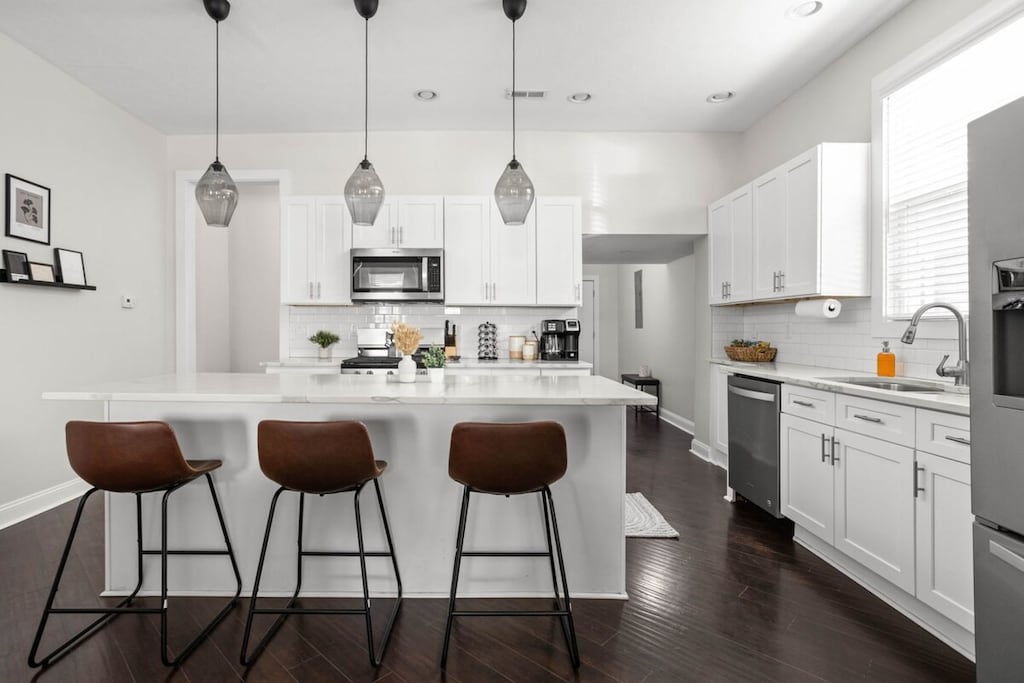 Our inviting kitchen, designed with a spacious countertop for both food preparation and dining. Perfect for hosting those family dinners!