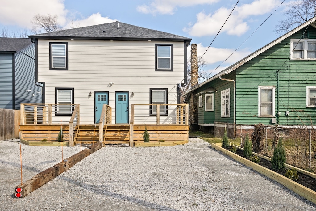 Exterior: Experience modern charm with vibrant blue doors, spacious deck, and quaint garden vibes! Please note this is a duplex and parking is designated to one side! Parking for up to 2 cars!