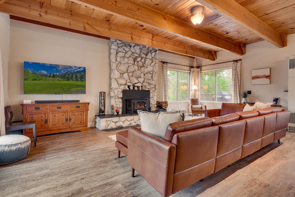 Living area with comfy couch, flat screen TV. and fireplace