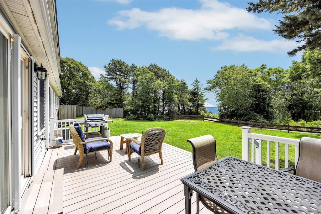 Grill out and unwind on the spacious back deck with a peekaboo view of the ocean just beyond the trees.