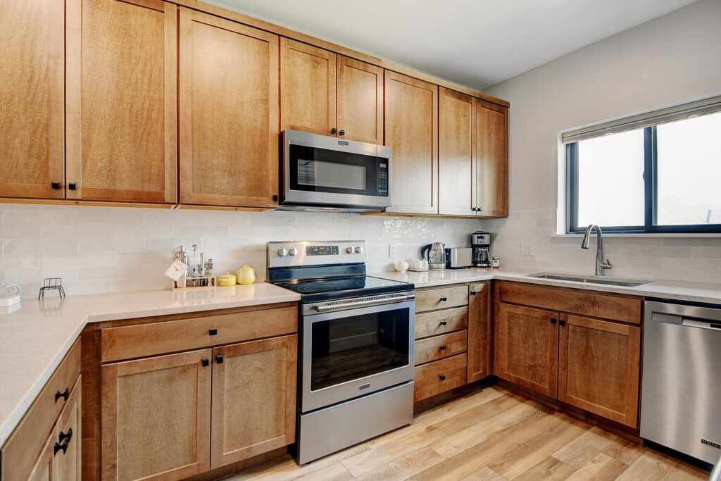 High End Appliances And Custom Granite Countertops Throughout