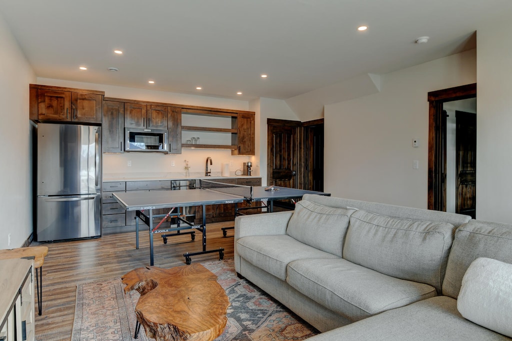Lower LIving Room with PIng Pong Table, Play Station 5 and 73" Smart TV and Secondary Kitchenette