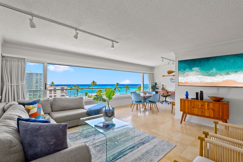 Welcome to our bright and open living area with panoramic ocean views, blending comfort with a serene coastal vibe for a perfect retreat.