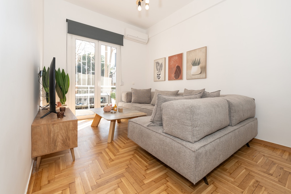 The bright and tastefully decorated living room welcomes you back from your adventures in Athens.