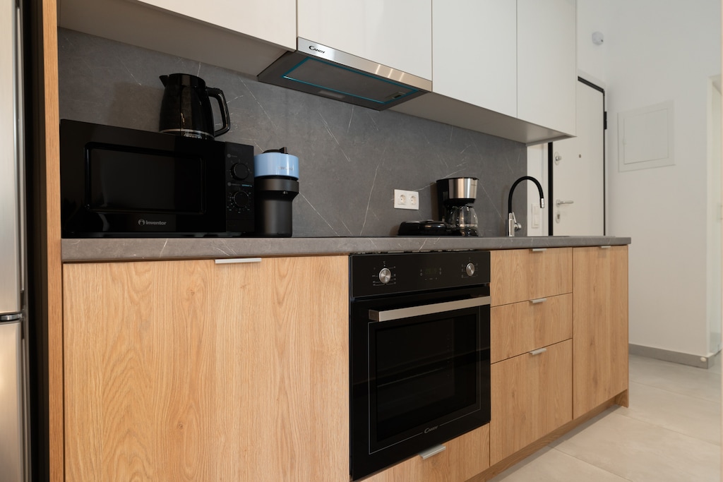Sleek, stylish and well equipped, the kitchen adds a modern touch to the space.