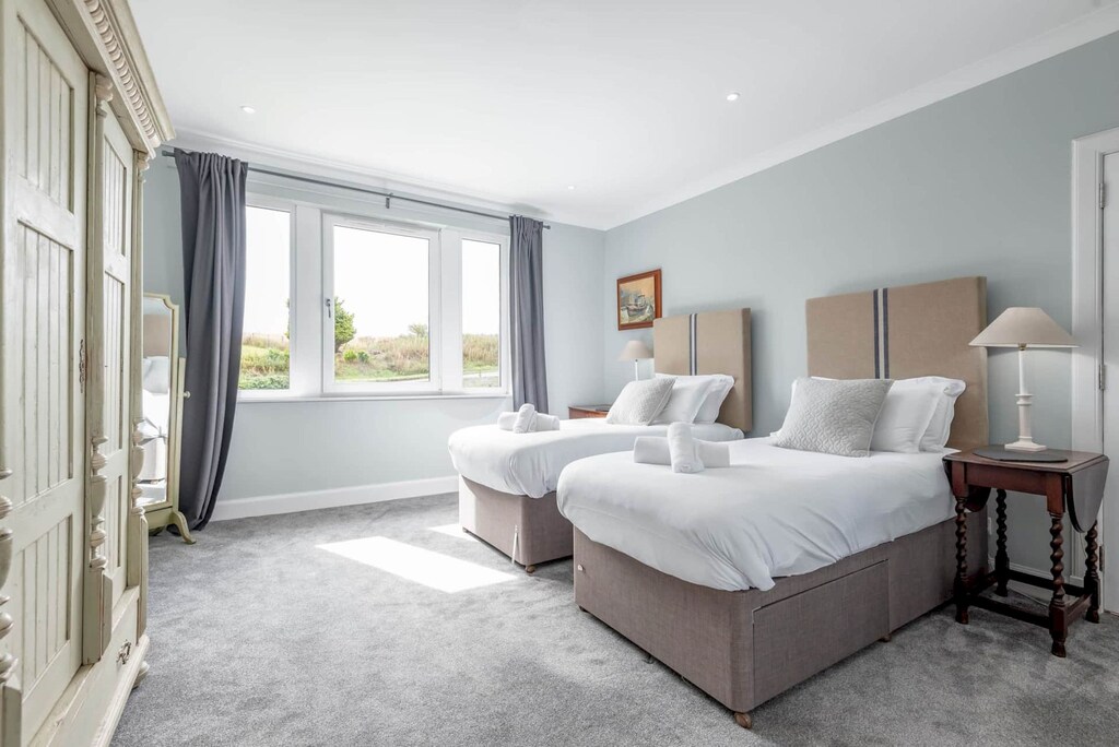 Master bedroom with beds made as twins.